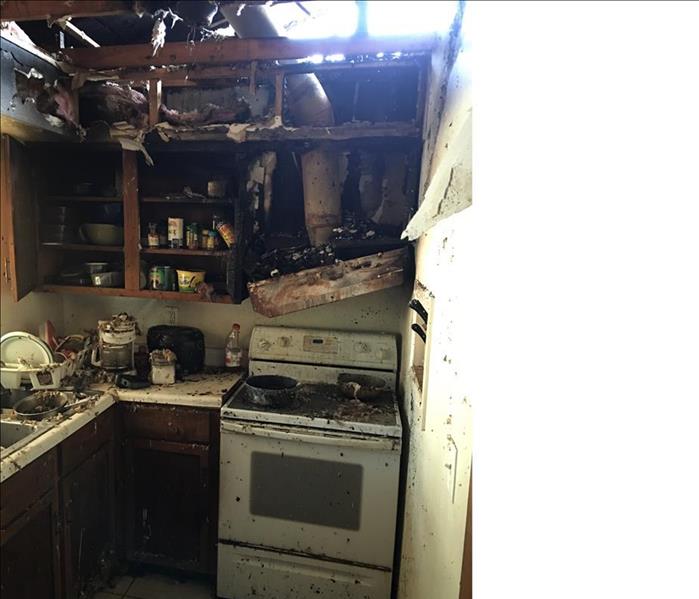 Fire damaged kitchen, roof opened letting in light