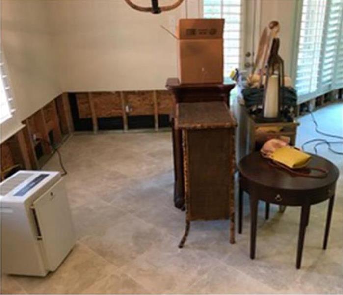 shot of clean floor and cut out at the 2-foot mark, damaged wallboard, furnishings on the floor