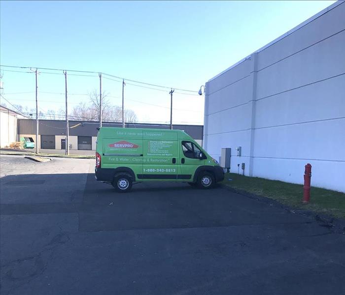 SERVPRO green van parked at commercial site