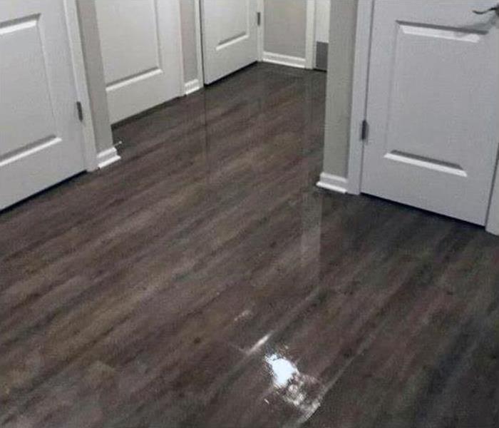 Wet hardwood floors due to flood damage in this home